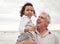 Beach, happy and elderly man with his grandchild on a family vacation during spring time. Travel, happiness and retired