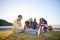 Beach, happy and family relax on vacation, bonding and having fun together on grass on mockup space. Grandparents, smile