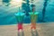 Beach holidays background with two cocktails In mermaid tail glass near swimming pool in luxurious hotel