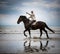 Beach horse rider pointing