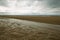 Beach of Houlgate in Normandy with cloudy sky and water on the sand 3