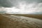 Beach of Houlgate in Normandy with cloudy sky and water on the sand 4