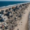 A beach with houses and debris on it.