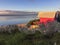 Beach huts and native coastal vegetation.