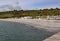 Beach huts on the shingle beach viewed from the Cobb at Lyme Regis, Dorset, England