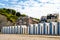 Beach huts at Yport Habour and Beach side in Normandy during cloudy sky