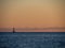 Beach in the Ibiza island with sailboat in the water during sunset.