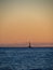 Beach in the Ibiza island with sailboat in the water during sunset.