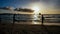 Beach on the island of Boracay in the rays of the evening sunset. Silhouettes of people playing a ball on the beach and