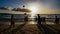 Beach on the island of Boracay in the rays of the evening sunset. Silhouettes of people playing a ball on the beach and