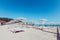 Beach and Italian Tyrrhenian coast with a multitude seamsless of beach umbrellas, deckchairs for vacationers. Trees and nature in