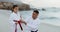 Beach, karate or training with a father and daughter together outdoor for a self defense workout. Fitness, family and