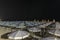 Beach and lido at night with umbrellas and deck chairs