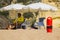 A beach life guard under the shade of his sun brolly while scanning the beach in Albuferia in Portugal