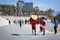 Beach lifeguard men are walking along the promenade of Barceloneta beach