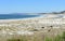 Beach with lighthouse, sand dunes and waves at Rias Baixas region. LariÃ±o, Carnota, CoruÃ±a, Galicia, Spain.