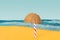Beach with a lonely sun umbrella abstract concept. Candy cane and half of fresh raw organic coconut in front with blue ocean color