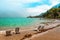 Beach lounger at lake shore gardasee with wavy water, malcesine