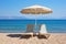 beach loungers under a parasol by the sea