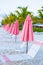 Beach lounges under an umbrella on white sand