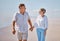 Beach, love and senior couple holding hands while walking for health, exercise and wellness. Happy, romance and elderly