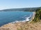 Beach lovers facing the Pacific Ocean from the fort of Niebla village. Estuary and mouth of the Valdivia River. Valdivia, Los Rios