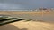 The beach at low tide by stormy and windy weather with Margate Harbor Arm in the background, Margate, Kent, UK