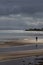 Beach and man in sunlight at whiting bay on arran