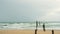 Beach in the morning, strong wave attacking shore In old broken wooden bridge with soft blue cloudy sky background in summer rainy