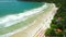 Beach with mountains and ocean with waves in Santa Catarina, Florianopolis. Aerial view