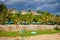 The beach in Mui Ne village. Palm trees, resort houses, street cafes