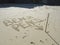 `Beach Pencil` written in sand