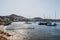Beach, pier and yachts moored by the beach of Agios Ioannis, Mykonos, Greece