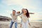 Beach, piggyback and portrait of parents and children for family holiday, summer vacation and weekend. Nature, travel