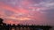 Beach, pink sky, lamp, bridges and people