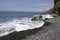 Beach Ponta de Sol pebble beach and rocky green coastline with cliffs, Madeira island