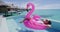 Beach Pool Holidays Vacation Woman in bikini in inflatable pink flamingo toy