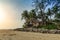 Beach poor huts, shacks among palm trees at tropical sunrise, Cabarete, Dominican Repiblic