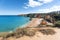 Beach in Portugal town. Ocean waves on peaceful seaside at sunny day of Algarve area