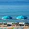 Beach resort umbrella lounger square format blue sea