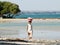 Beach retracting water and walking woman with basket on her head, Madagascar