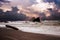 Beach and rocks and wild waves on a cloudy day