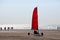 Beach sailing cart (Blokart) with red sail on the beach in IJmuiden on March 20th 2011