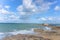 Beach in Saint-Malo France, Brittany, blue skies clouds waves beach low tide rock fortress in ocean