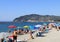 .The beach of San Bartolomeo al Mare with the promontory of Capo Berta in the background.. Imperia-Italy