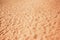 Beach sand as background. Terracotta color Sandy texture
