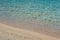 Beach sand and blue ocean water closeup
