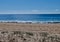 Beach with sand, dunes, plants and blue ocean