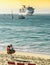 Beach scene with Mexican vendor on the beach and cruise ship at sea.