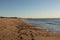 Beach scene at Sunset Beach in Cape May New Jersey. The pretty brown sand glistening of the suns golden hour glow.